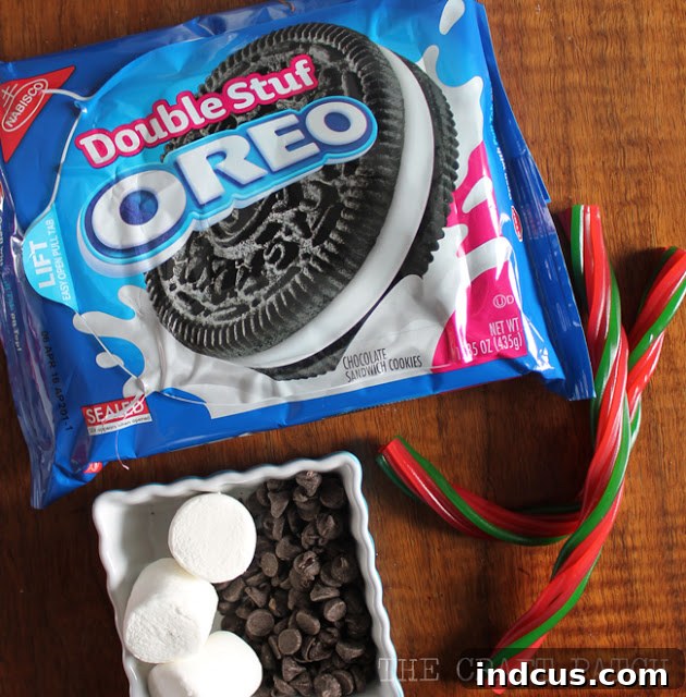 Key ingredients for crafting edible snowman top hat treats: classic Oreo cookies, soft marshmallows, flexible pull-apart licorice, and meltable chocolate chips.