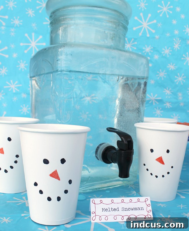 Refreshing 'Melted Snowman' water, playfully served in simple white cups adorned with hand-drawn snowman faces, an easy and cute drink idea for any winter party.