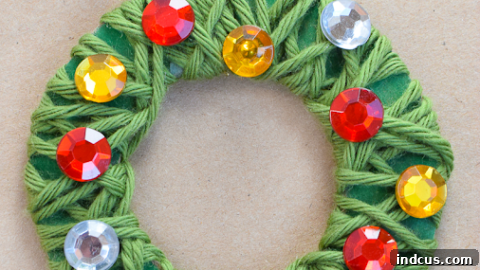 Yarn wrapped Christmas wreath ornaments with various decorations