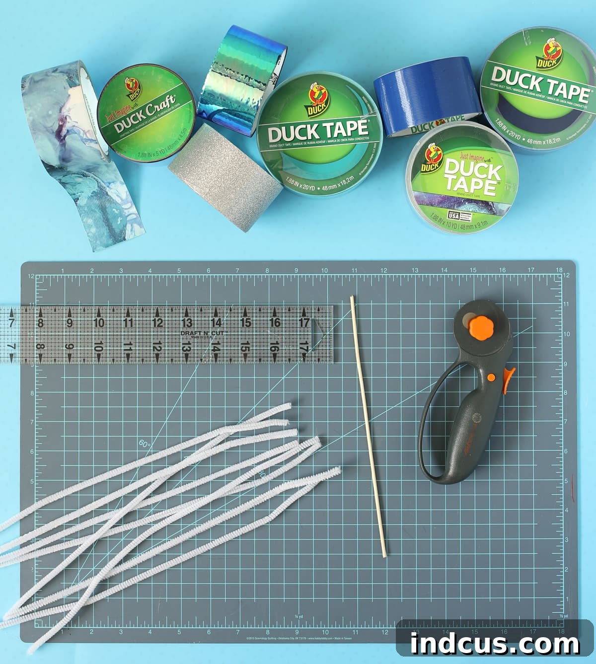 Collection of materials required to make Duck Tape beads, including various tapes and cutting tools