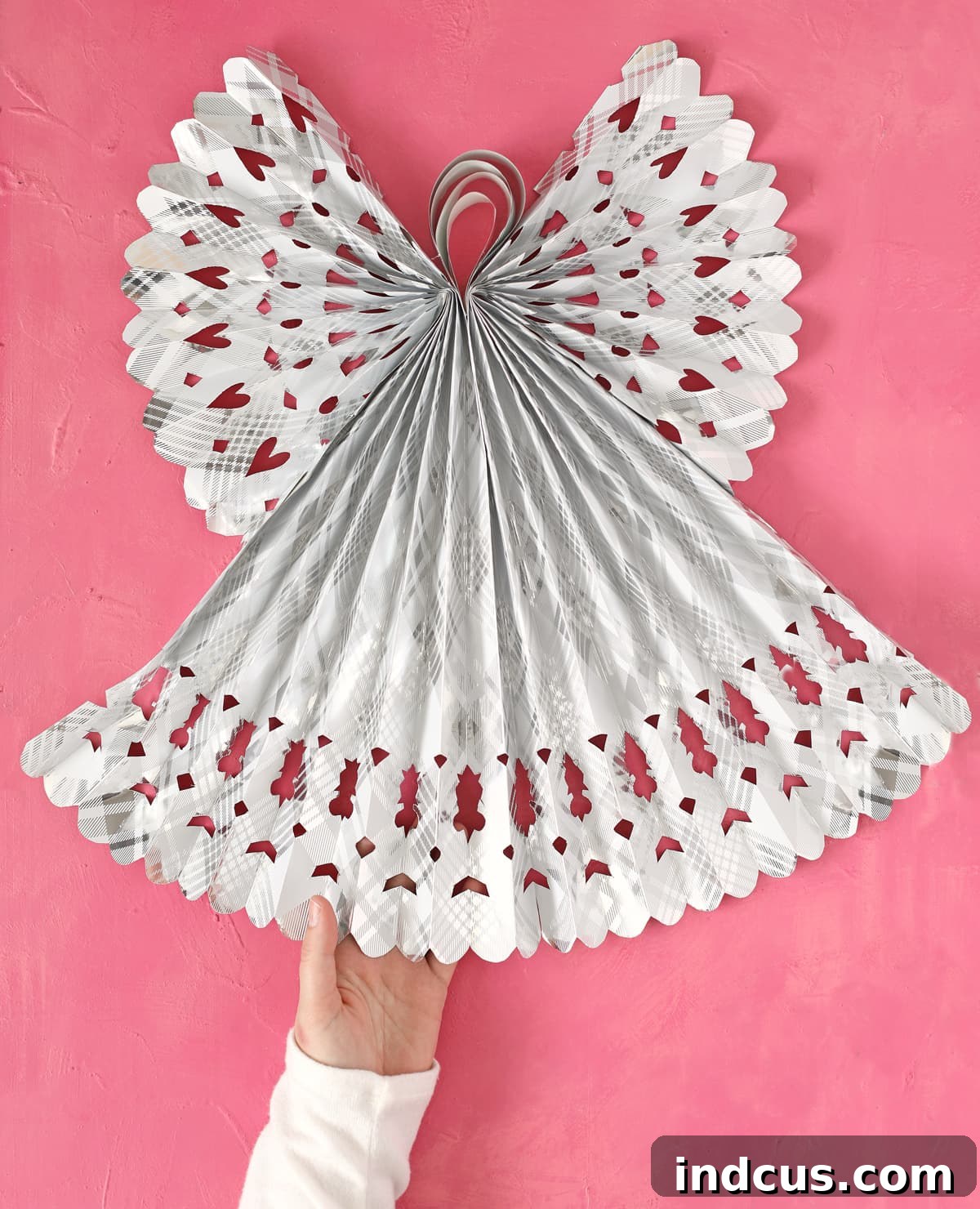 Impressive giant Christmas angel crafted from festive wrapping paper