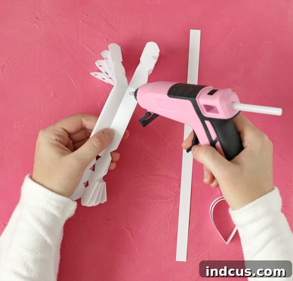 Instructions for assembling a folded paper angel, attaching the head