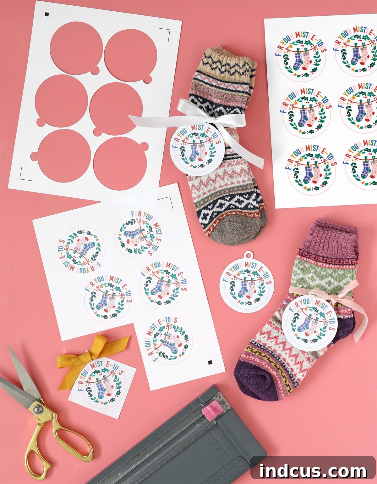 Multiple printable Christmas tags for giving socks displayed on a table