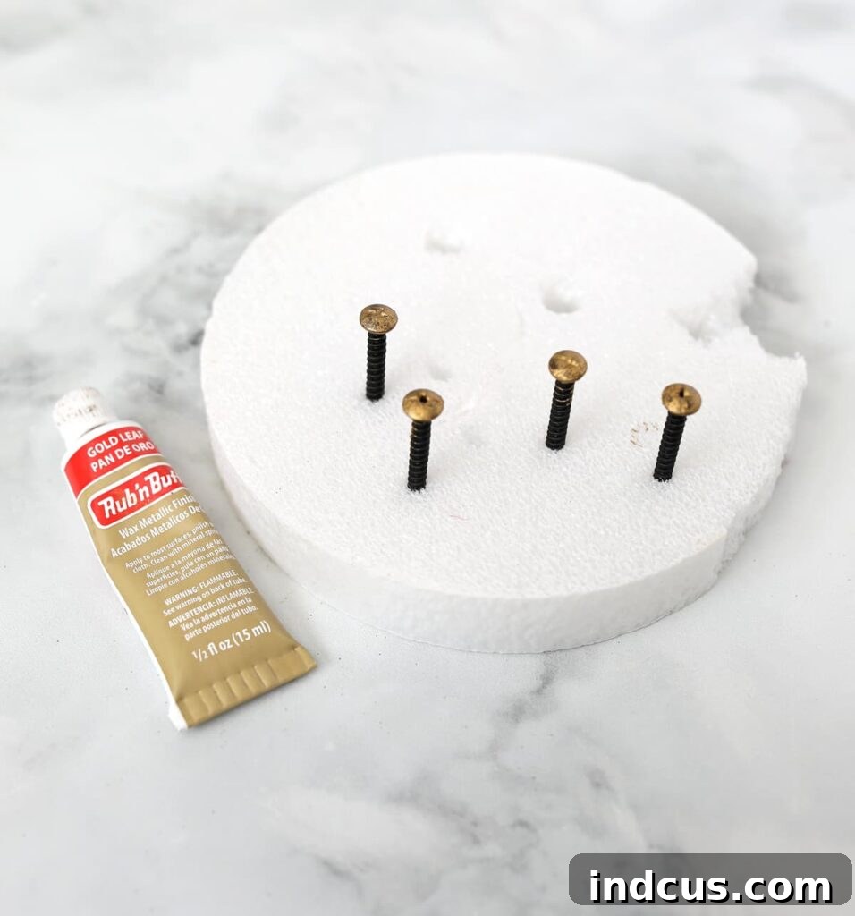 Warm Glow Wall Luminaires 5 Elegantly styled entryway featuring antique art flanked by gold metal wall sconces with realistic flickering battery-powered LED taper candles, enhancing ambiance and providing a cozy glow.