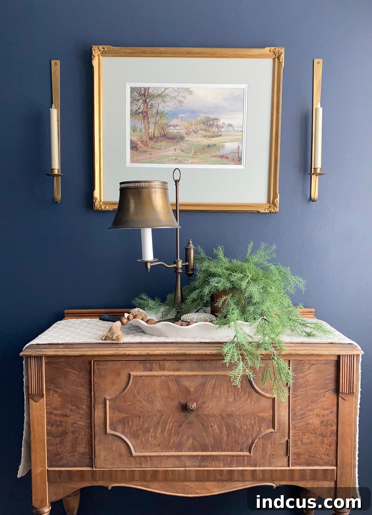 Warm Glow Wall Luminaires 7 Cozy entryway with European cottage style decor, featuring antique art flanked by gold candle wall sconces, radiating a warm and inviting ambiance with battery-powered LED candles.