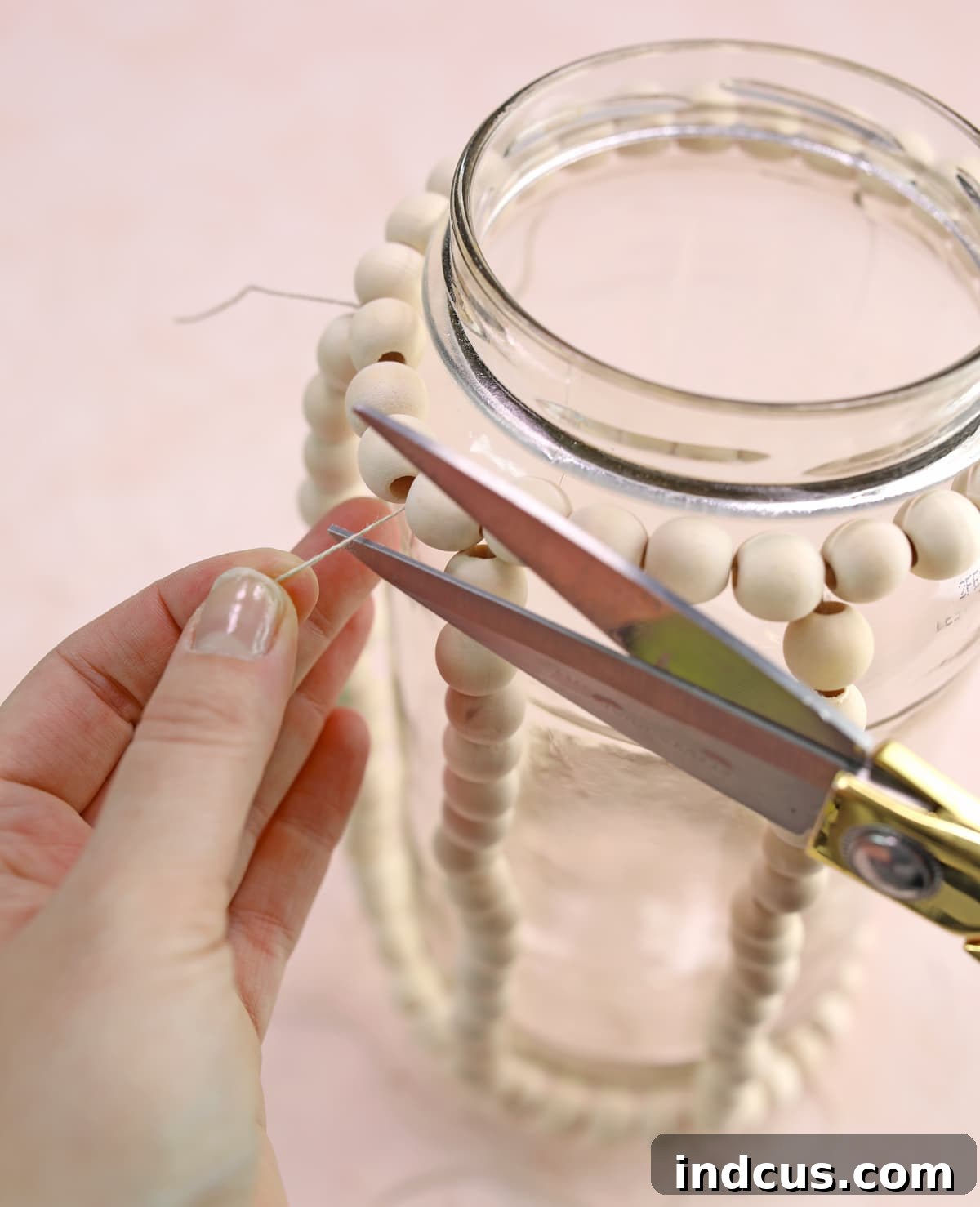 DIY wedding centerpiece made from repurposed glass pickle jars and wood beads