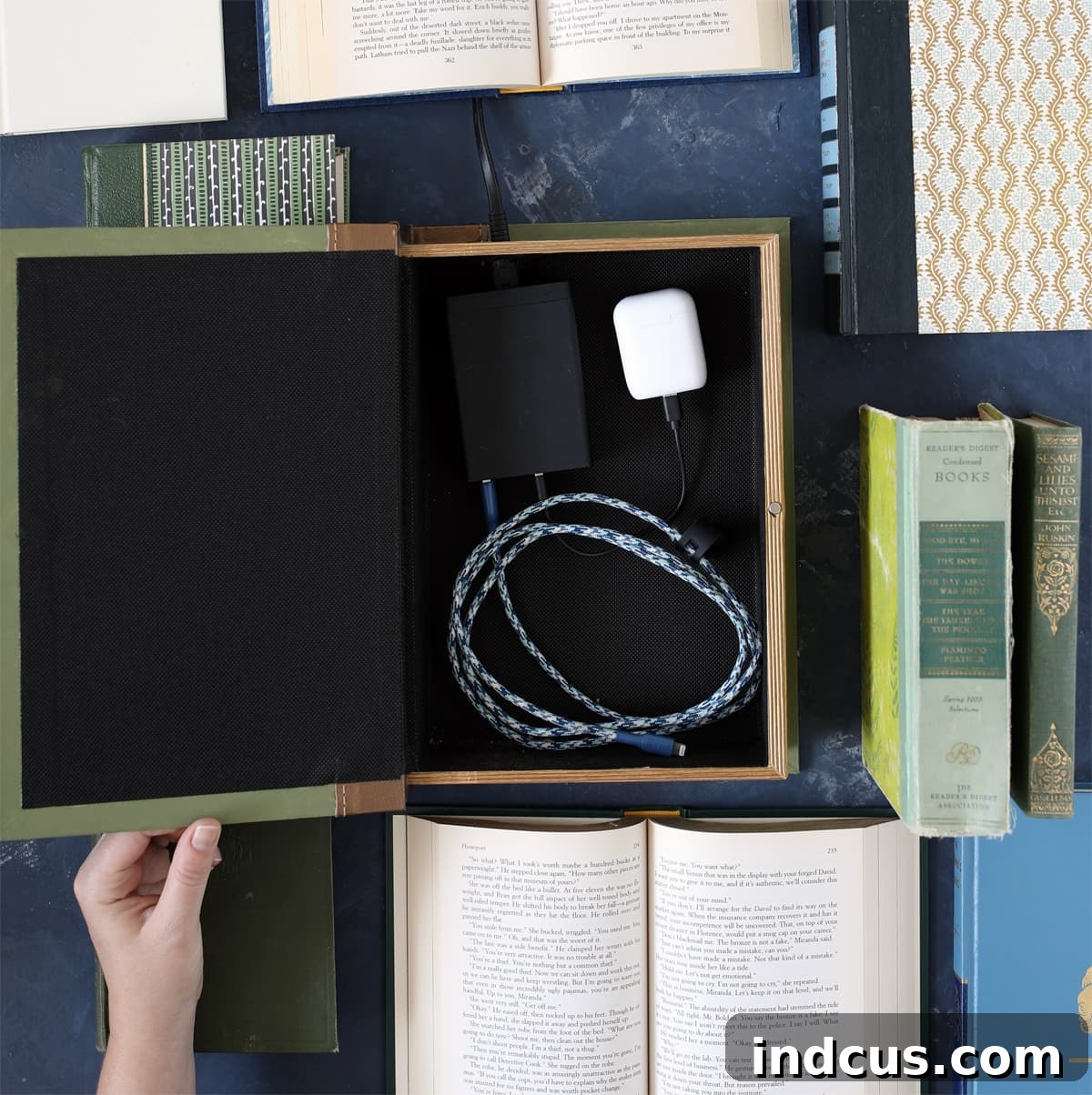 Secret Book Box Charging Hub 6 A smartphone is charging discreetly inside the repurposed decorative book box, cables hidden