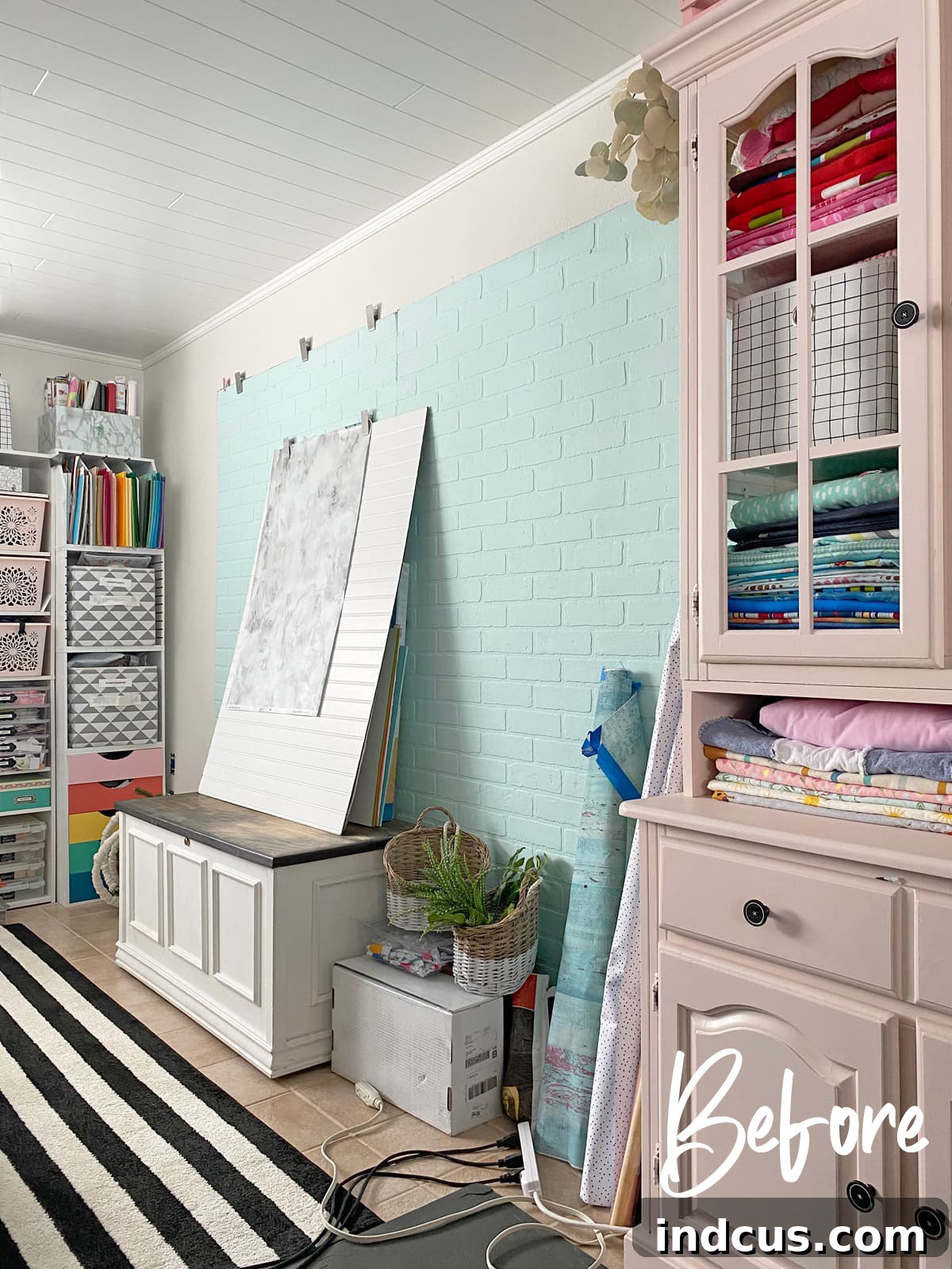 Before photo of a cluttered craft room area in need of built-in storage solutions