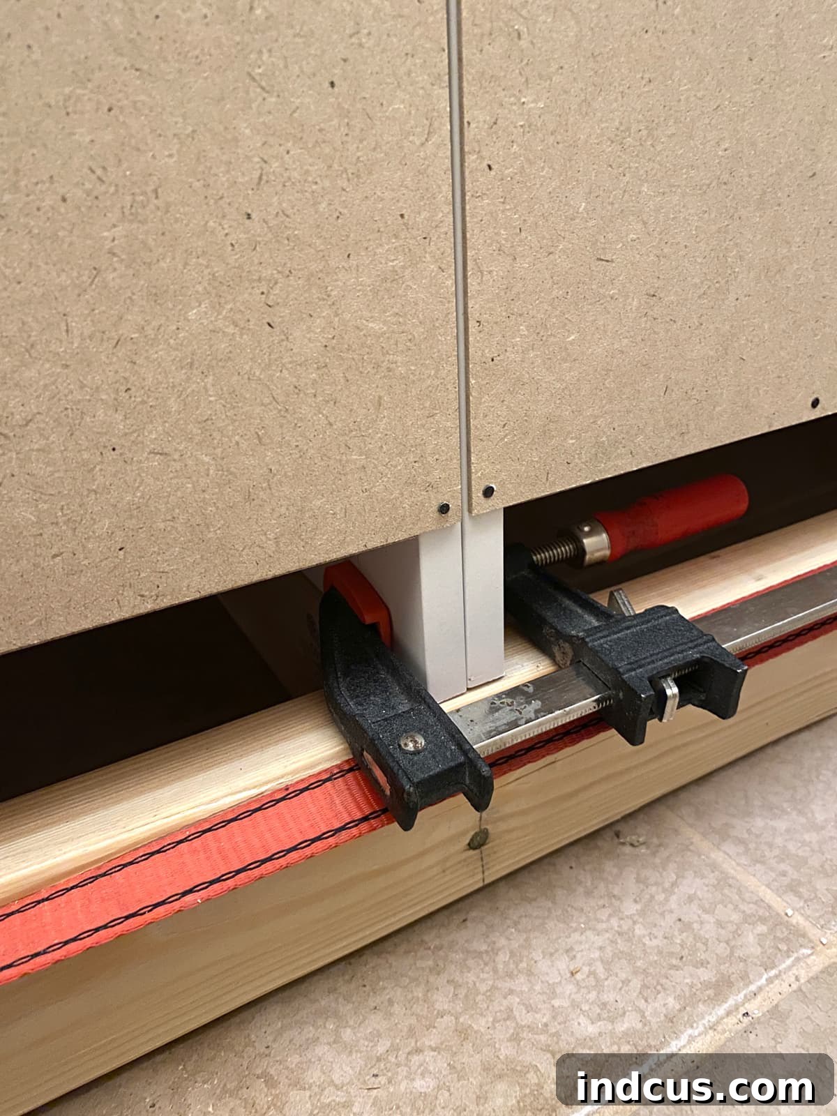 Clamping adjacent flat-pack cabinets together for precise alignment during built-in installation