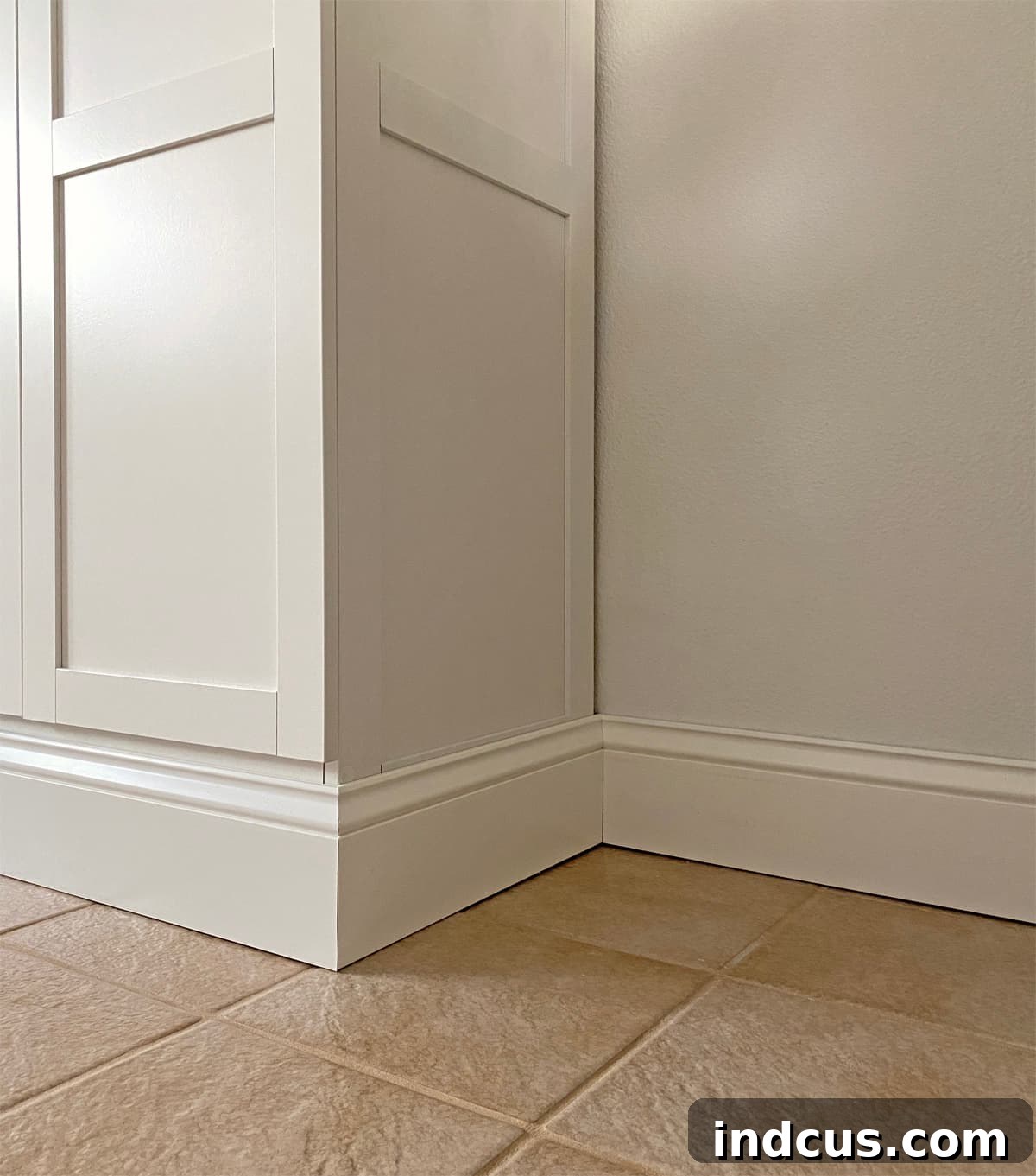Adding mitered baseboards to seamlessly wrap around DIY built-in cabinets, creating a custom finish