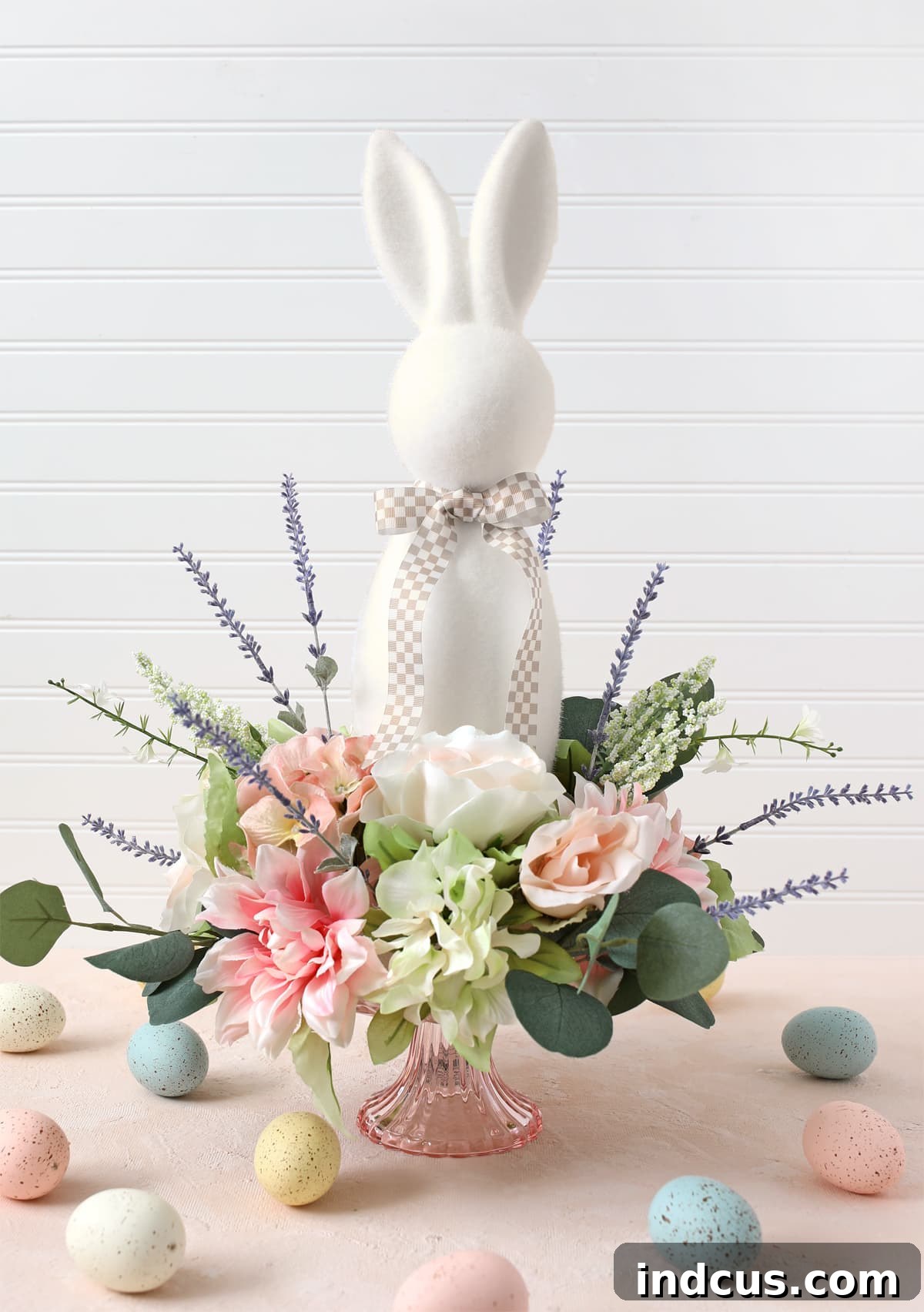 Beautiful Easter bunny floral spring centerpiece DIY tutorial with vibrant flowers on a cake stand