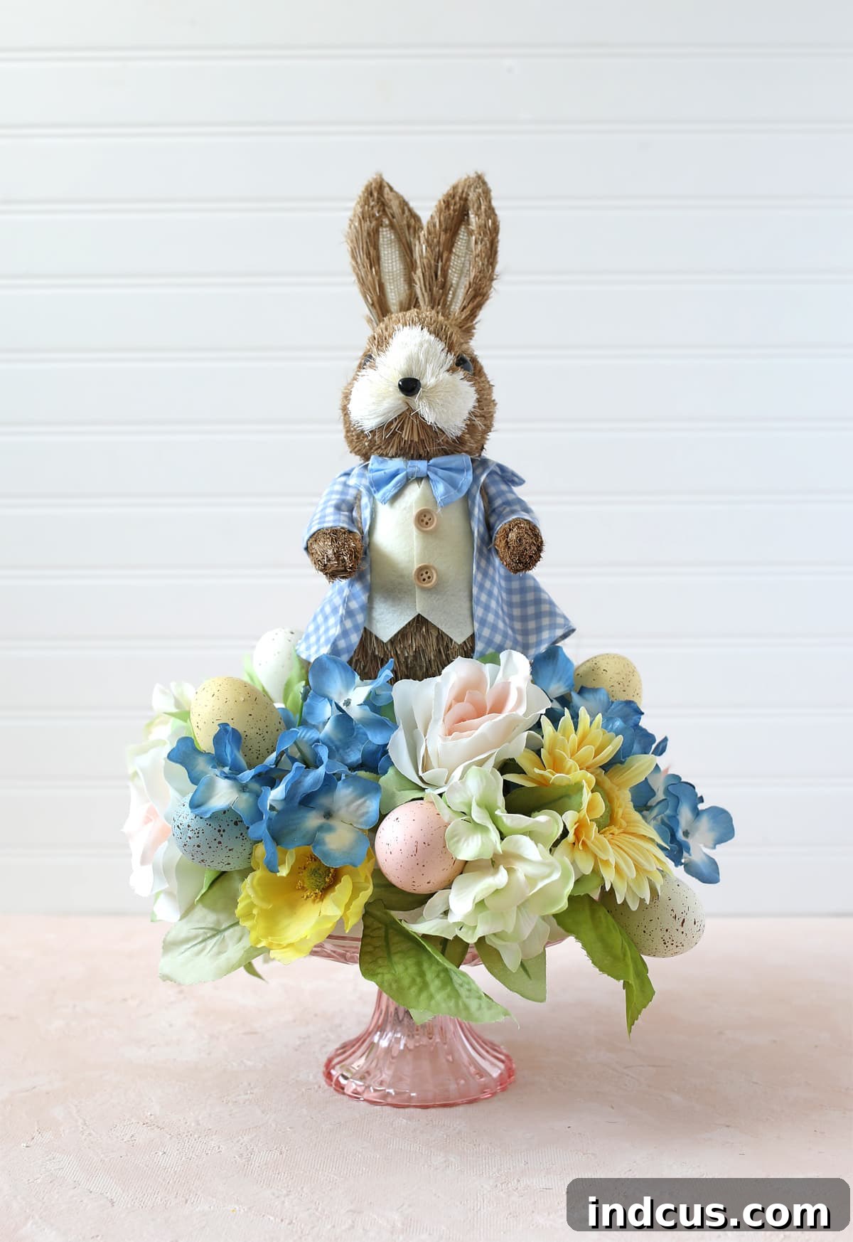 Easy spring floral and bunny centerpiece featuring a gingham bunny with blue and yellow flowers