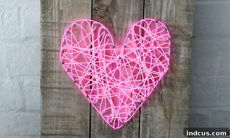 DIY string art neon heart sign, a modern Valentine's craft