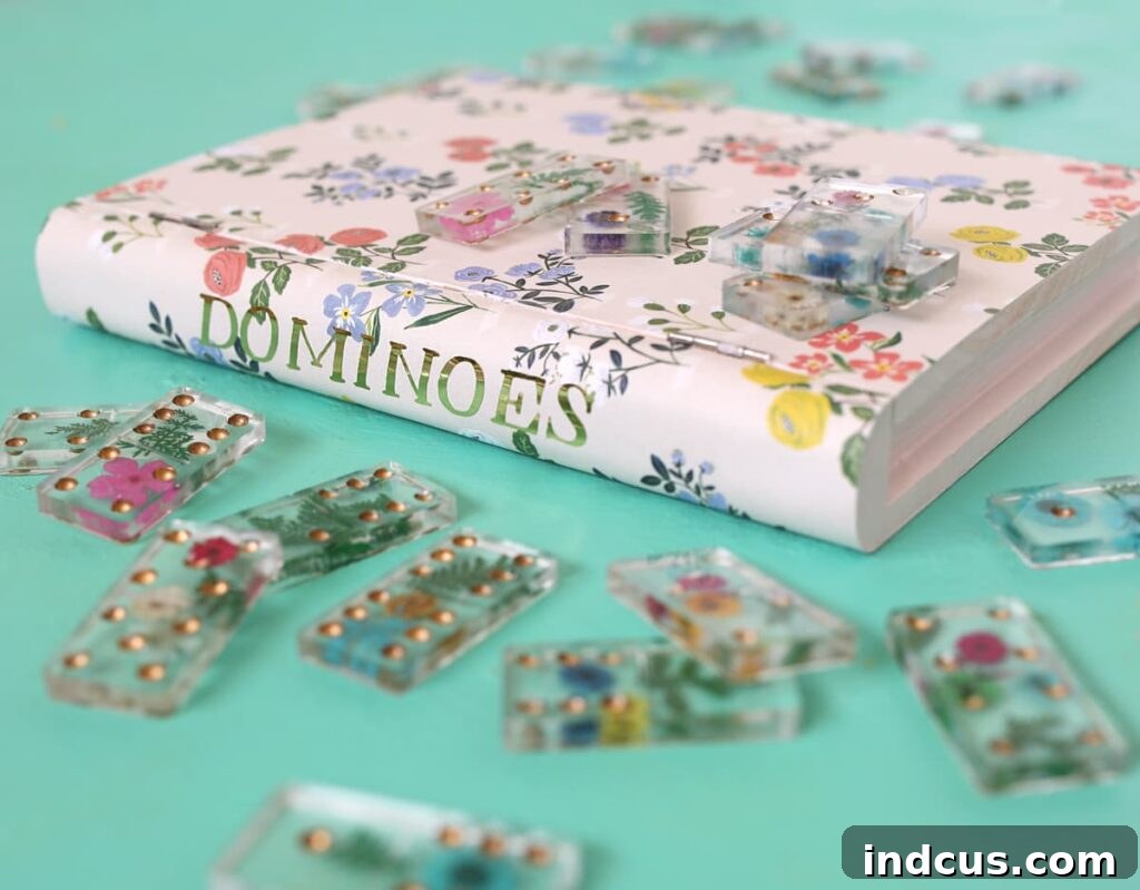 Complete DIY project featuring a beautiful set of custom resin dominoes with pressed flowers, displayed alongside their matching decorative book box.