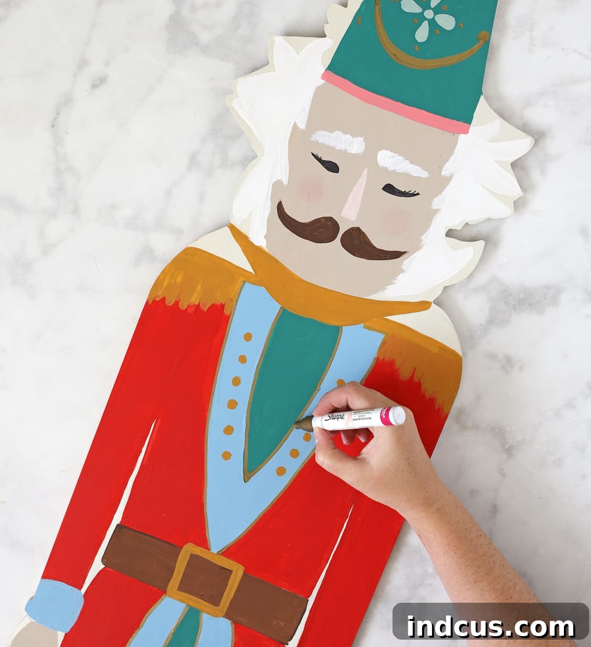 use paint pens to add details to painted wood crafts
