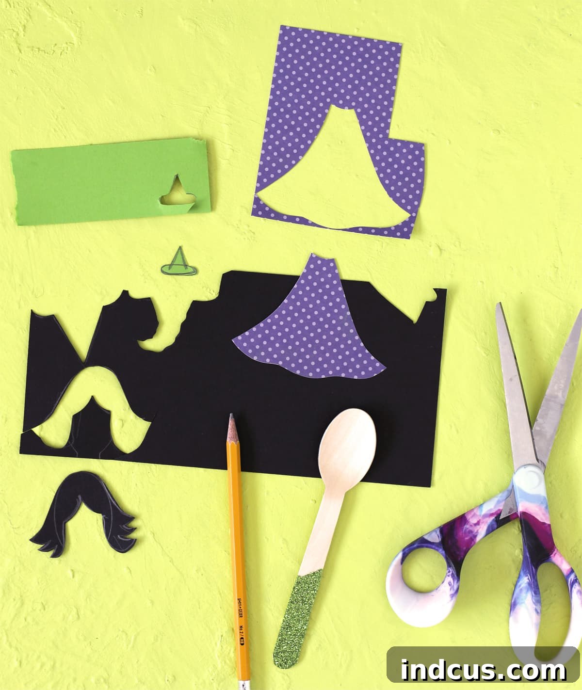 Cutting out paper shapes for witch dresses, hats, and hair