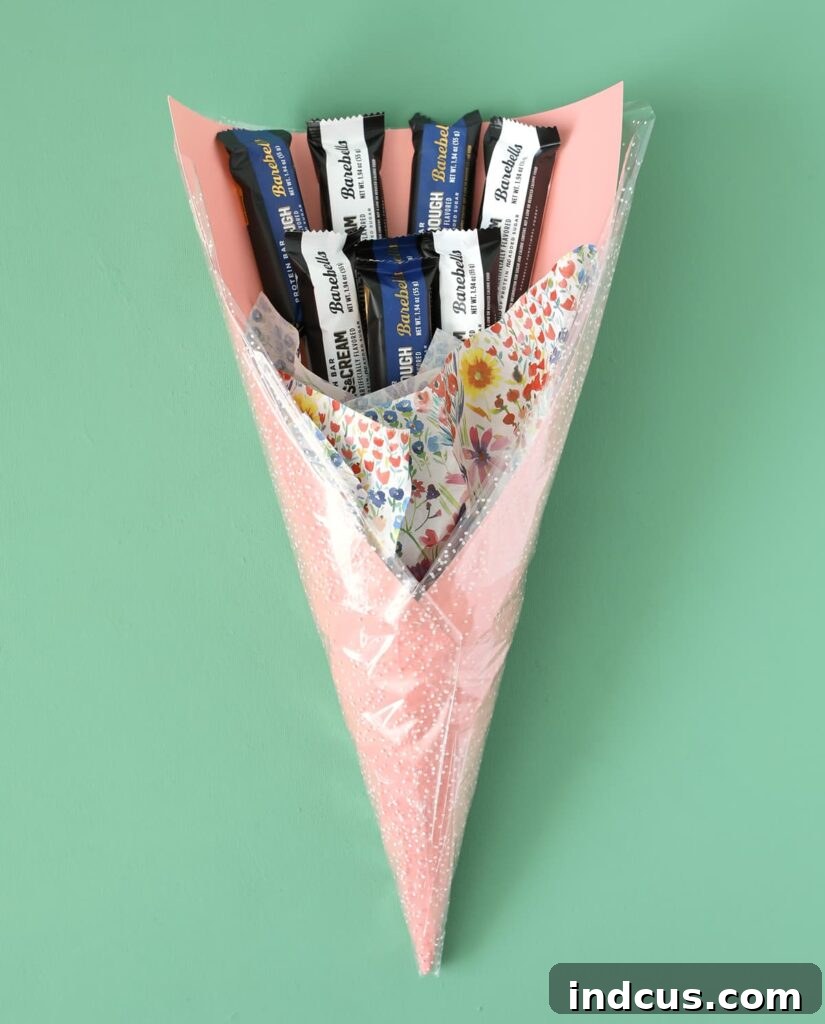 Adding colorful tissue paper to the cone of a gift bouquet for decorative flair and volume