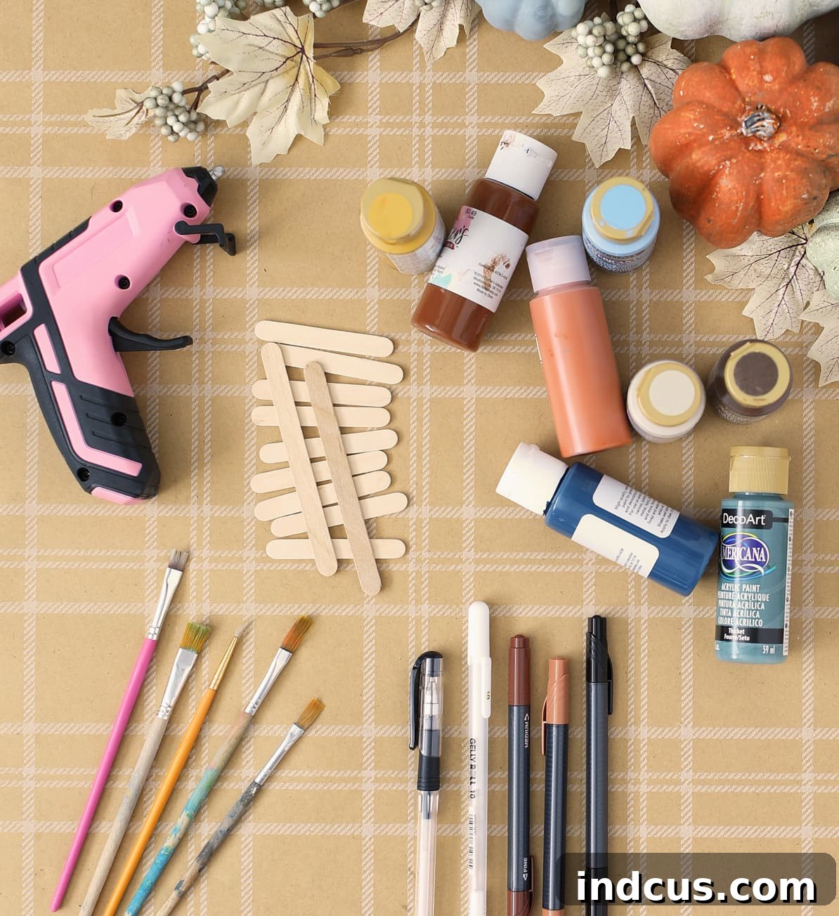 Supplies neatly arranged for making popsicle stick scarecrows