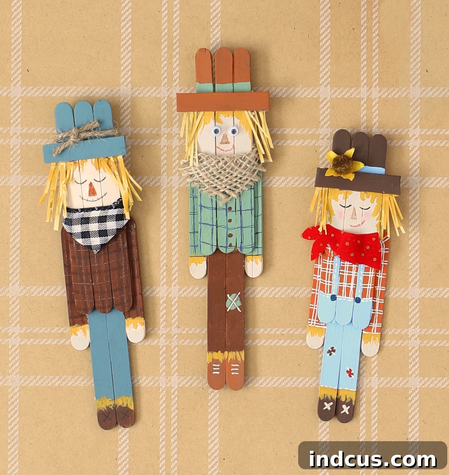 Finished collection of uniquely accessorized popsicle stick scarecrows