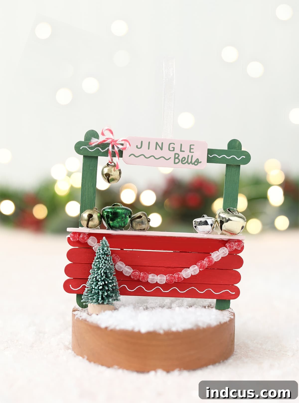 A charming jingle bell shoppe popsicle stick Christmas ornament