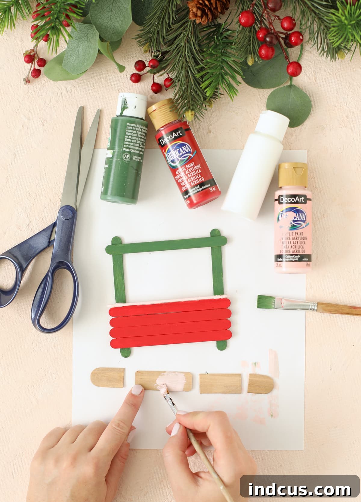 Cutting a jumbo popsicle stick to create a miniature shop sign
