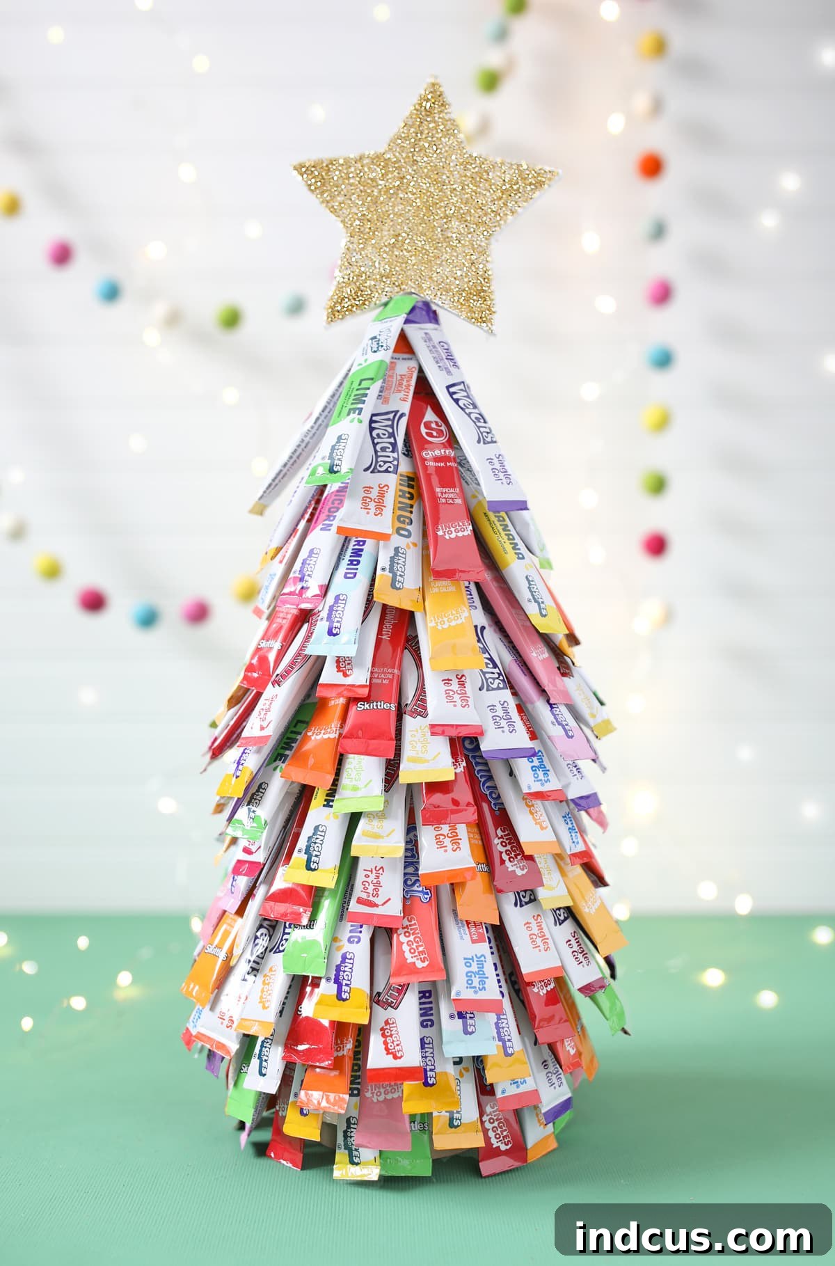A unique and festive drink packet Christmas tree displayed at a holiday party.