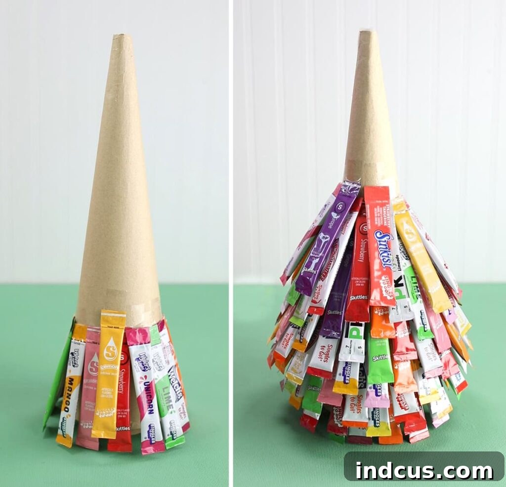 Applying drink packets in rows to create the shape of a Christmas tree.