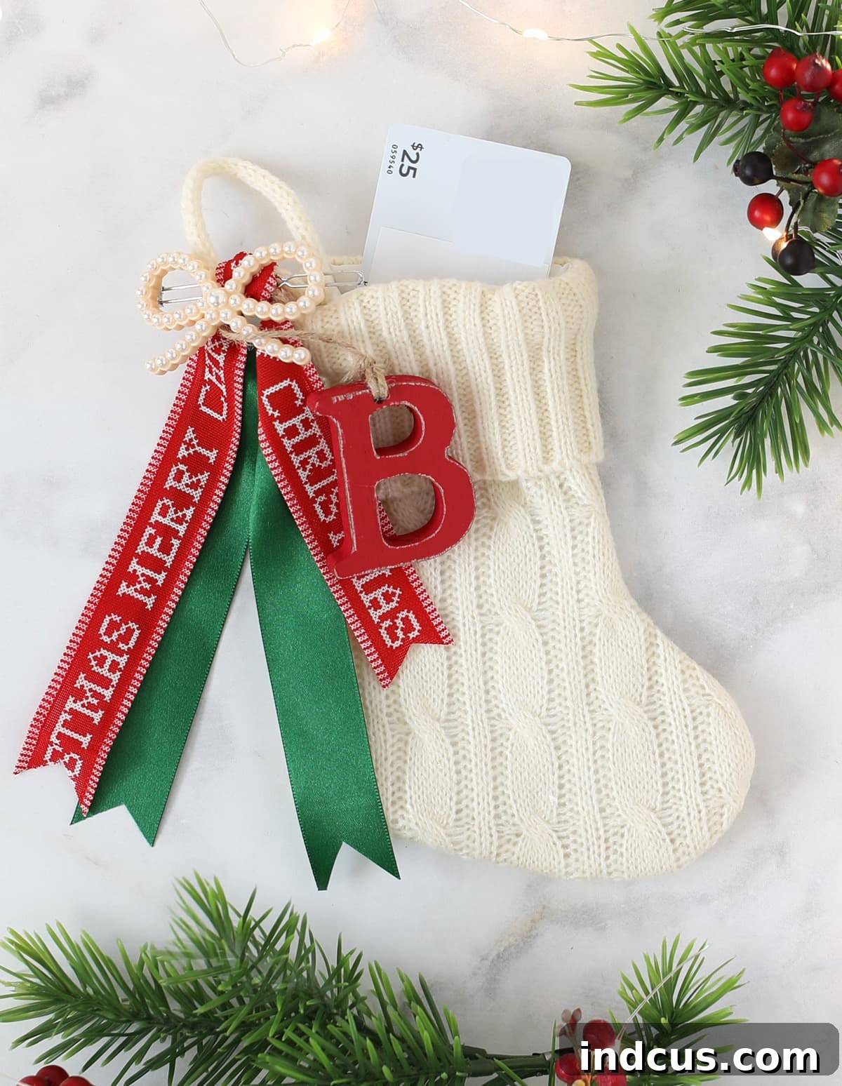 Close-up of a festive mini stocking holding a Christmas gift card