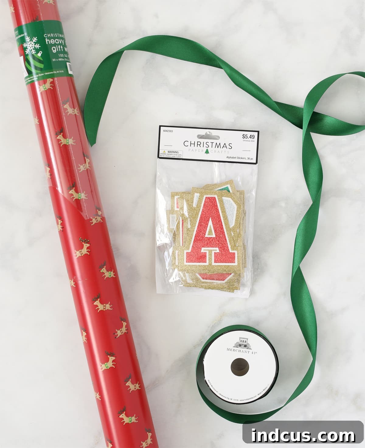 Personalizing Christmas gifts with trendy varsity letter stickers for a unique and custom presentation.
