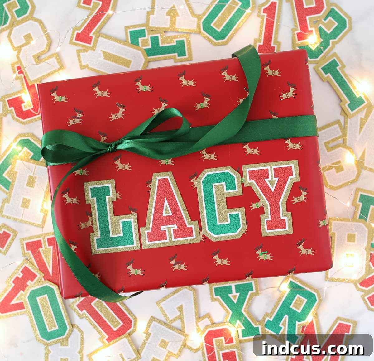 A creatively wrapped Christmas gift featuring initial-style varsity letter stickers for a personalized holiday touch.