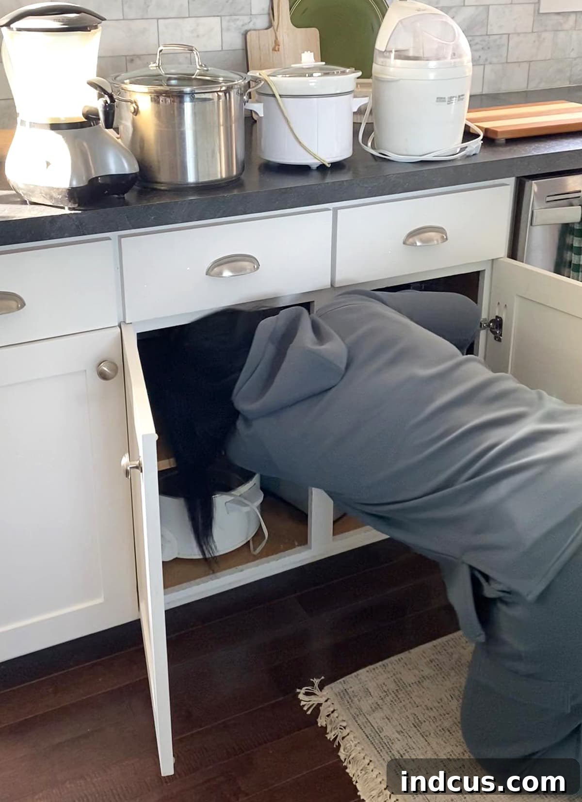 Before: Disorganized kitchen cupboard with small appliances