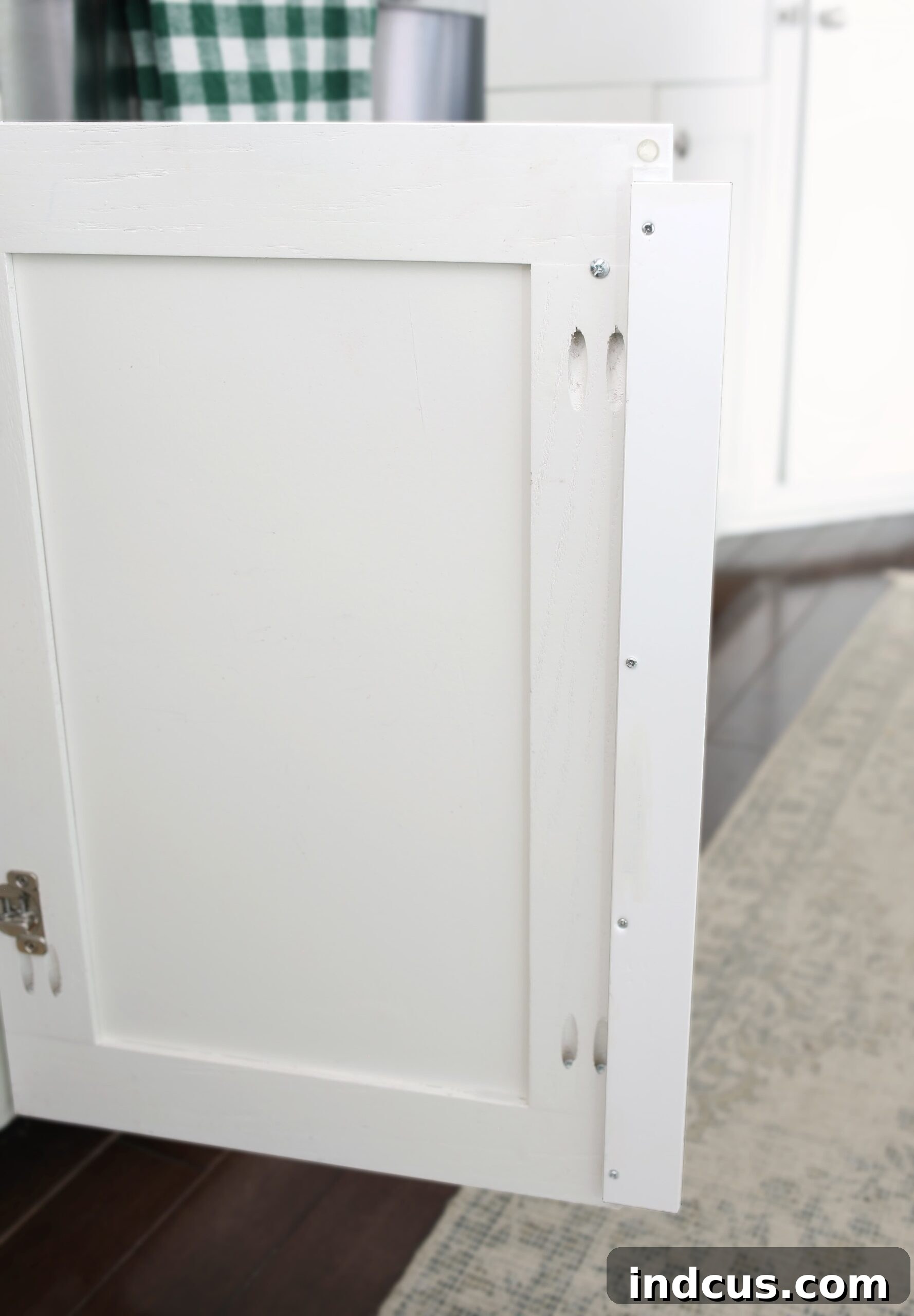 Wood filler piece screwed to the back of a cupboard door