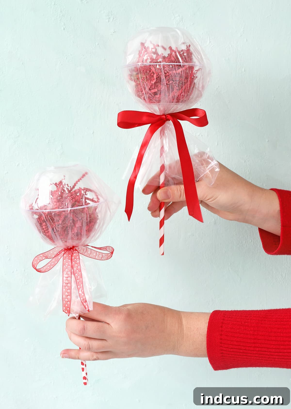 Finished giant lollipop gift made from Dollar Tree plastic bowls, filled with candy and wrapped with ribbon.