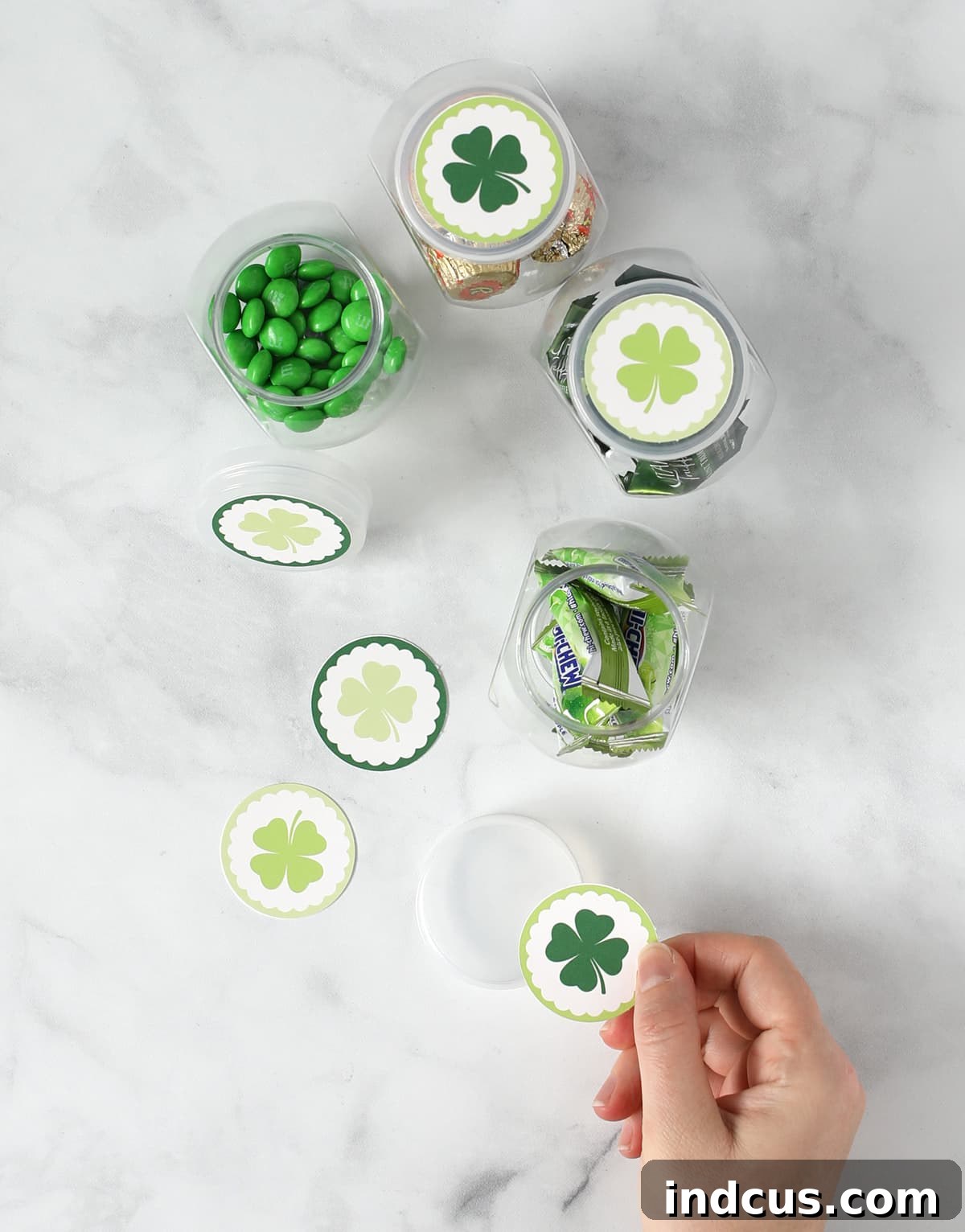 add shamrocks to candy jar lids for st. patrick's day decor