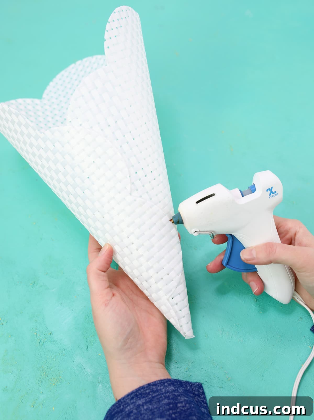 Rolling a placemat into a cone shape for a DIY basket