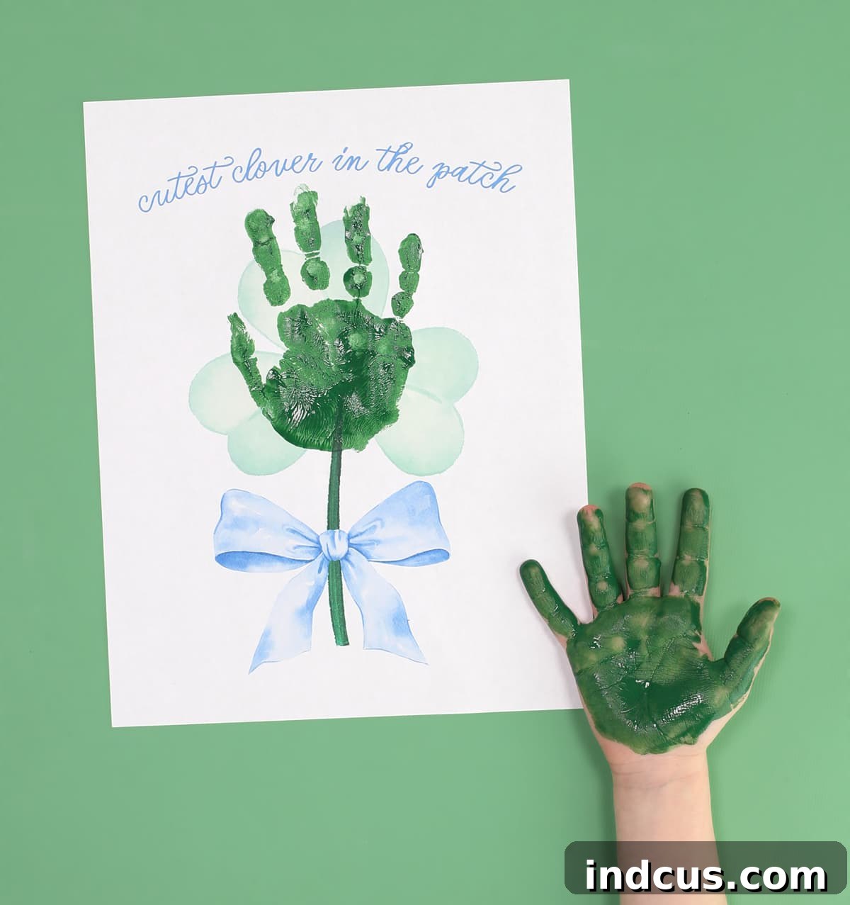 Placing the handprint on the St. Patrick's Day shamrock template