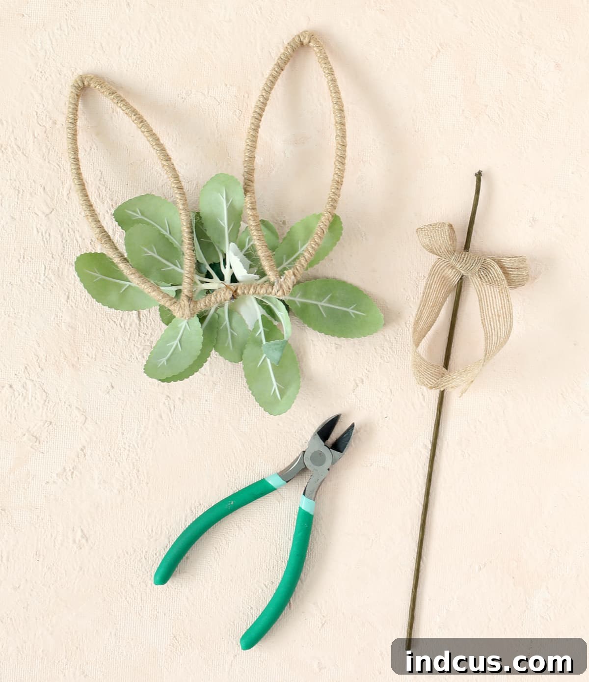 Carefully cutting the metal stick off the bunny ear pick using floral stem cutters.