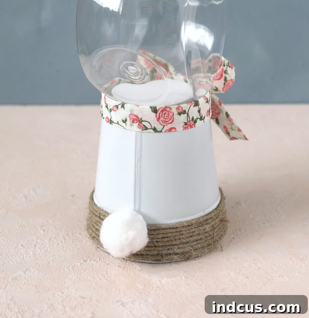 Attach a fluffy pom pom tail and a decorative ribbon to the bunny candy jar.