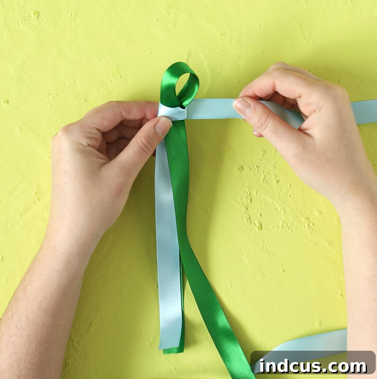 Weaving Beautiful Ribbon Leis 7 Wrapping the second ribbon around the base of the first loop