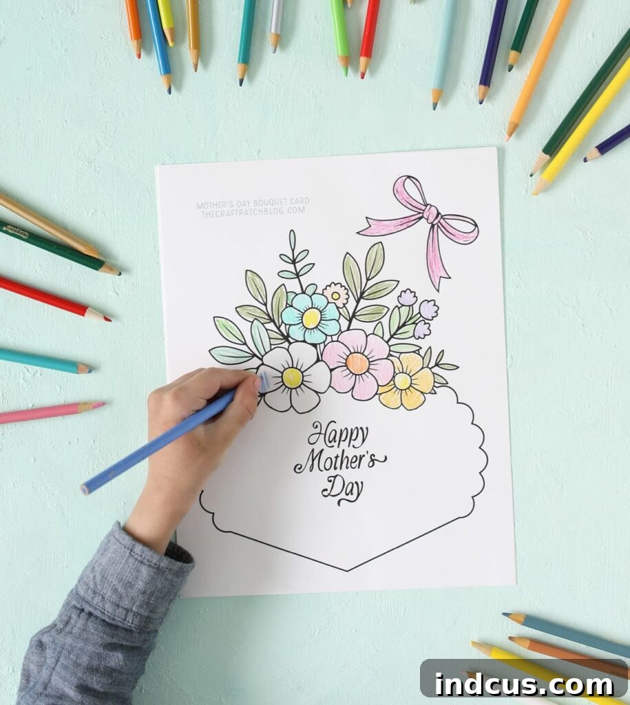 Child's hands coloring a printable Mother's Day flower bouquet card with crayons, adding vibrant colors to the design.