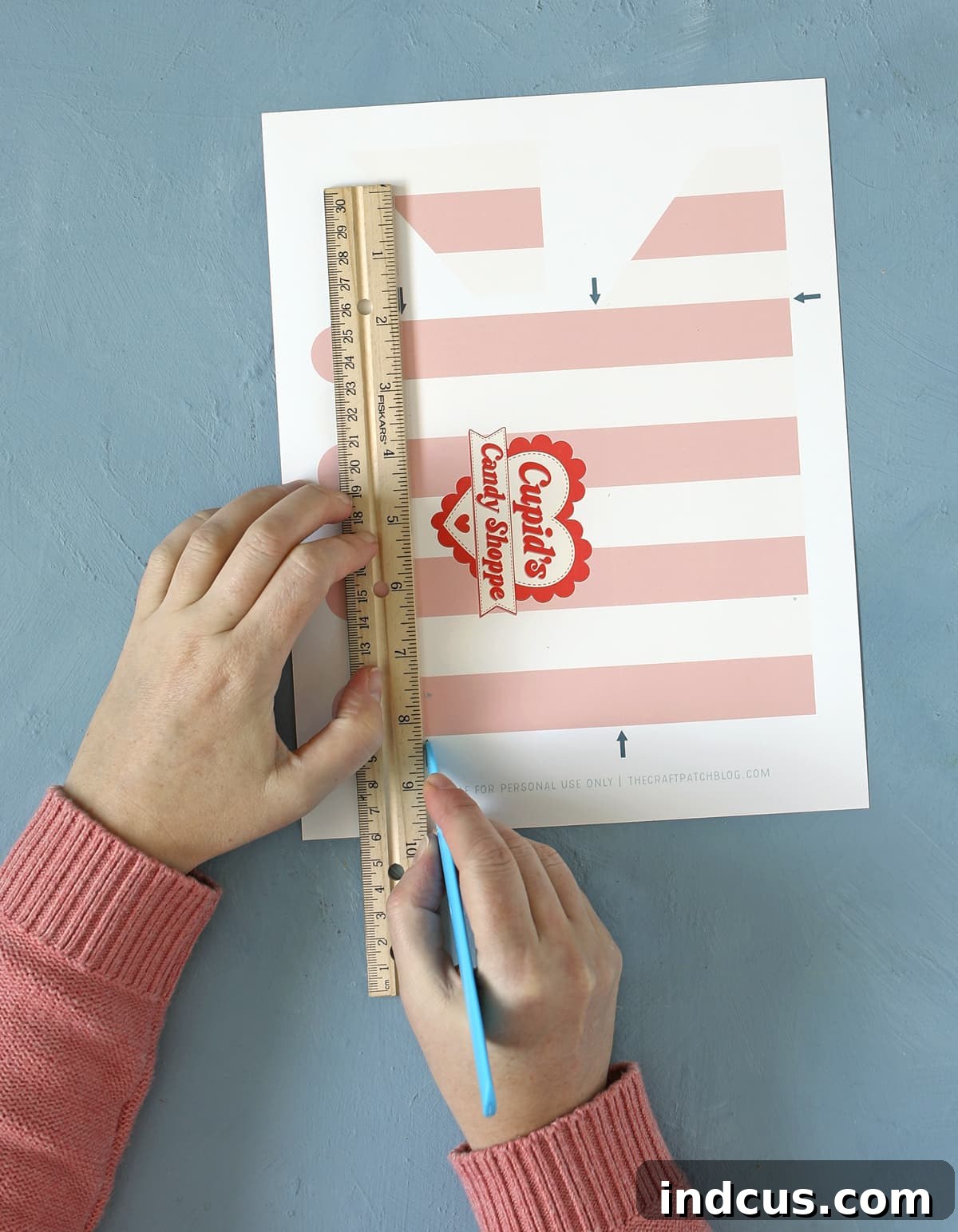 DIY Spooky Candy Shop 6 Detailed view of scoring paper with a ruler for the candy shop awning, showing precision for clean folds