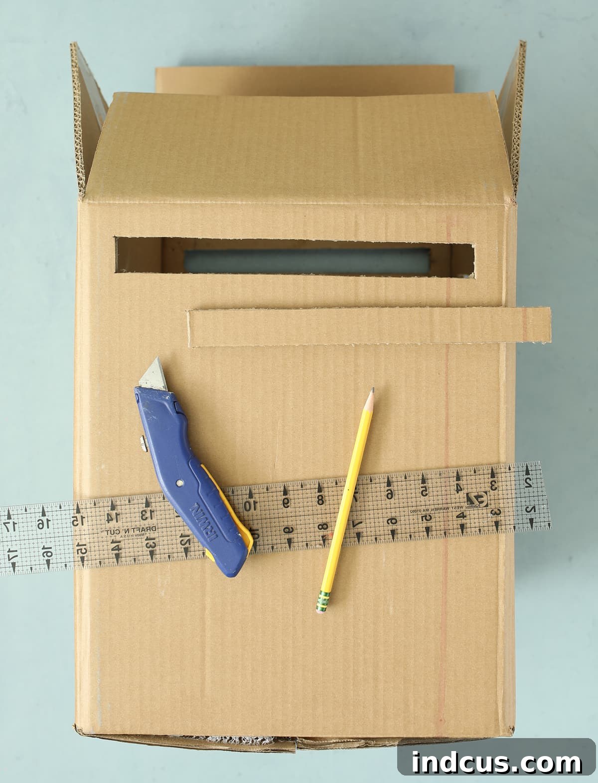 making a claw machine out of a cardboard box