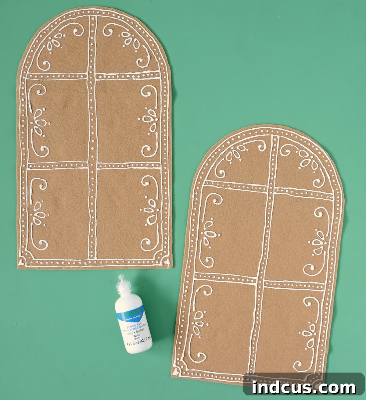 puff paint on felt for a gingerbread house, showing detailed window decorations