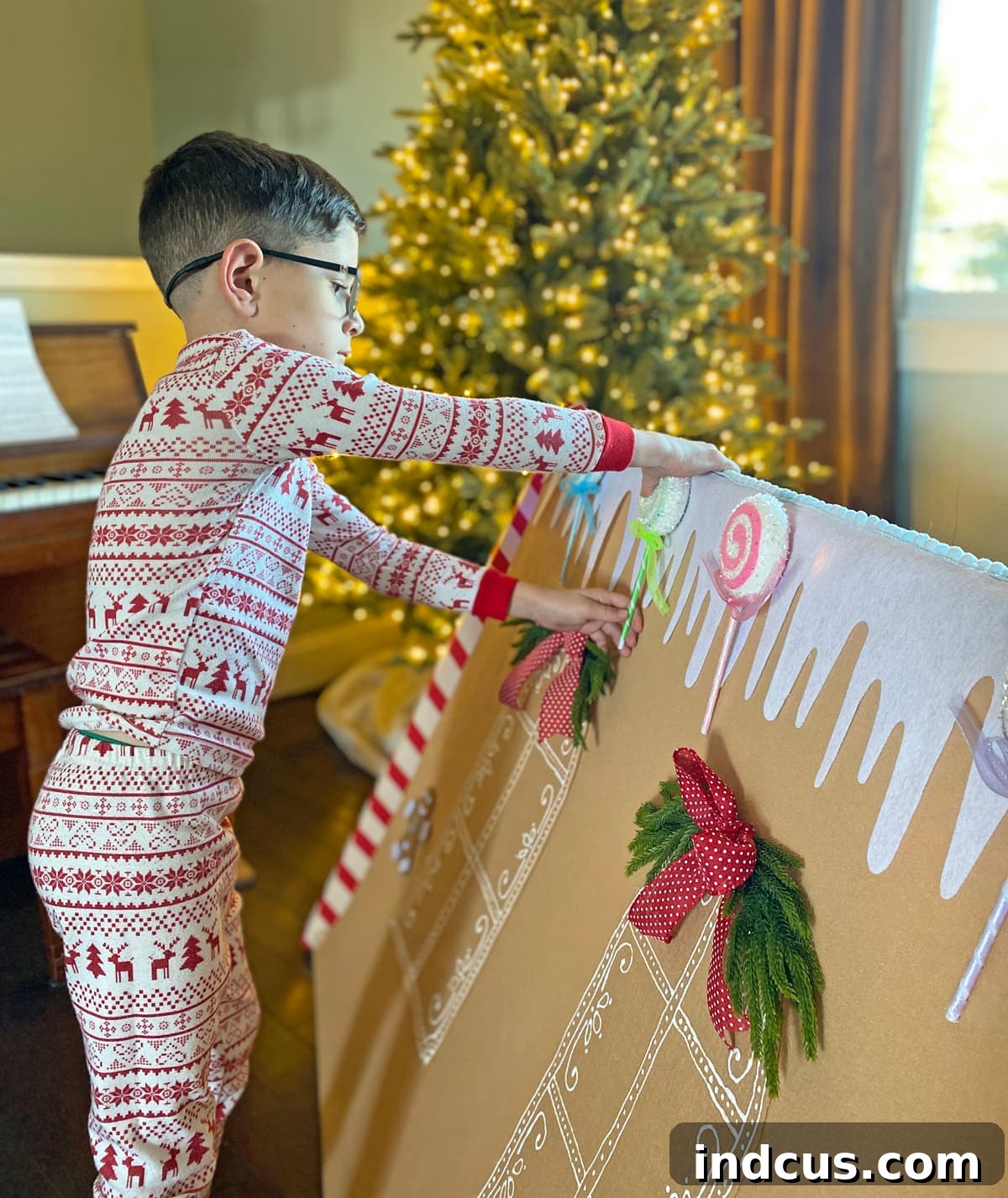 sticking candy to a felt gingerbread house play tent