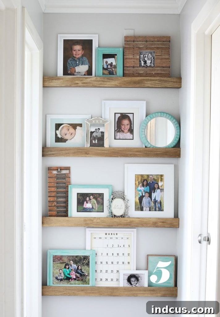 Styled picture ledge shelf DIY with various photo frames.