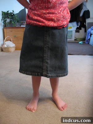 Toddler joyfully playing outdoors wearing her new upcycled denim skirt
