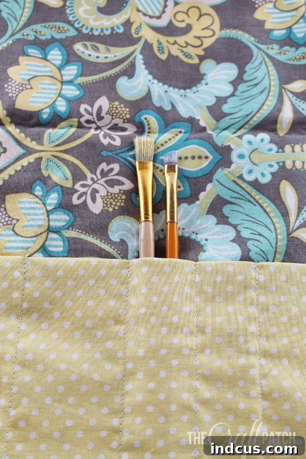 Image showing two elastic loops sewn onto the left edge of the fabric.