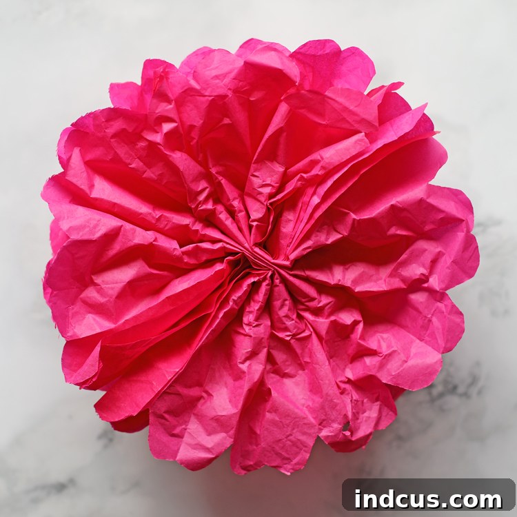 A perfectly spherical tissue paper pom pom, ideal for hanging decorations