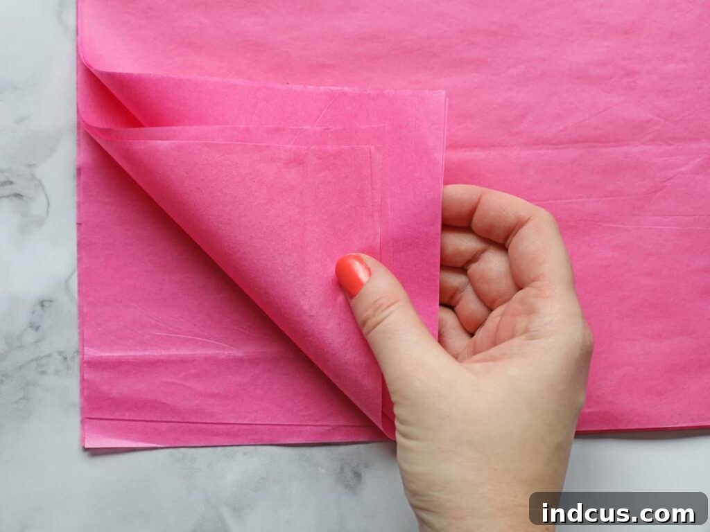 Step 1: Stacking multiple sheets of colorful tissue paper neatly