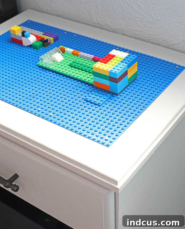DIY Lego table creation, showing the transformed furniture piece with Lego base plates and storage bins.